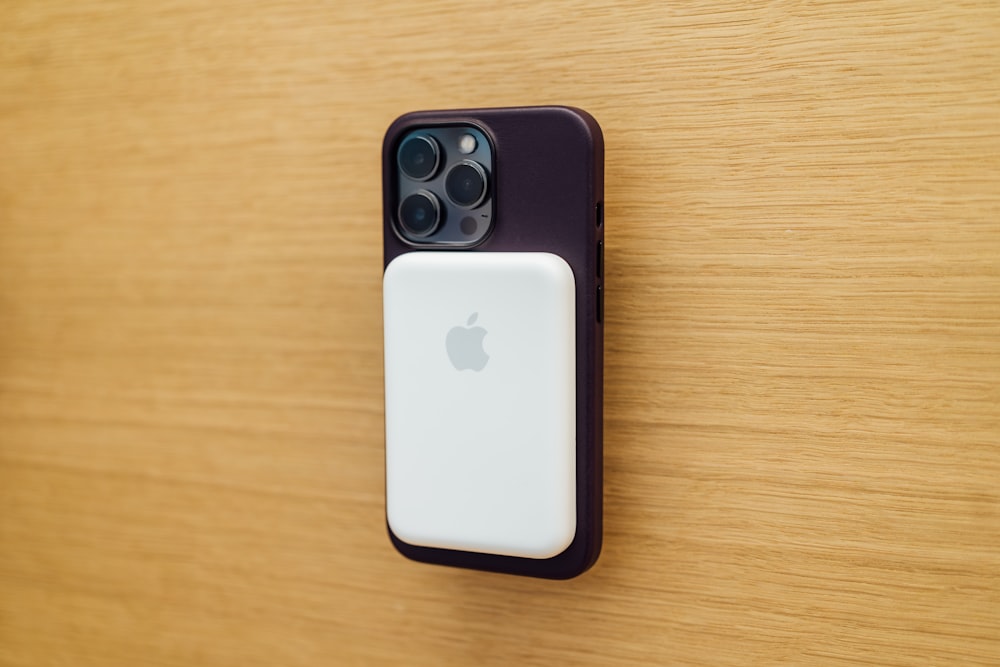 a close up of an iphone on a wooden surface