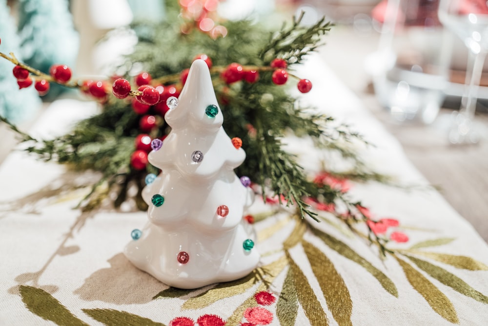 a small white christmas tree sitting on top of a table