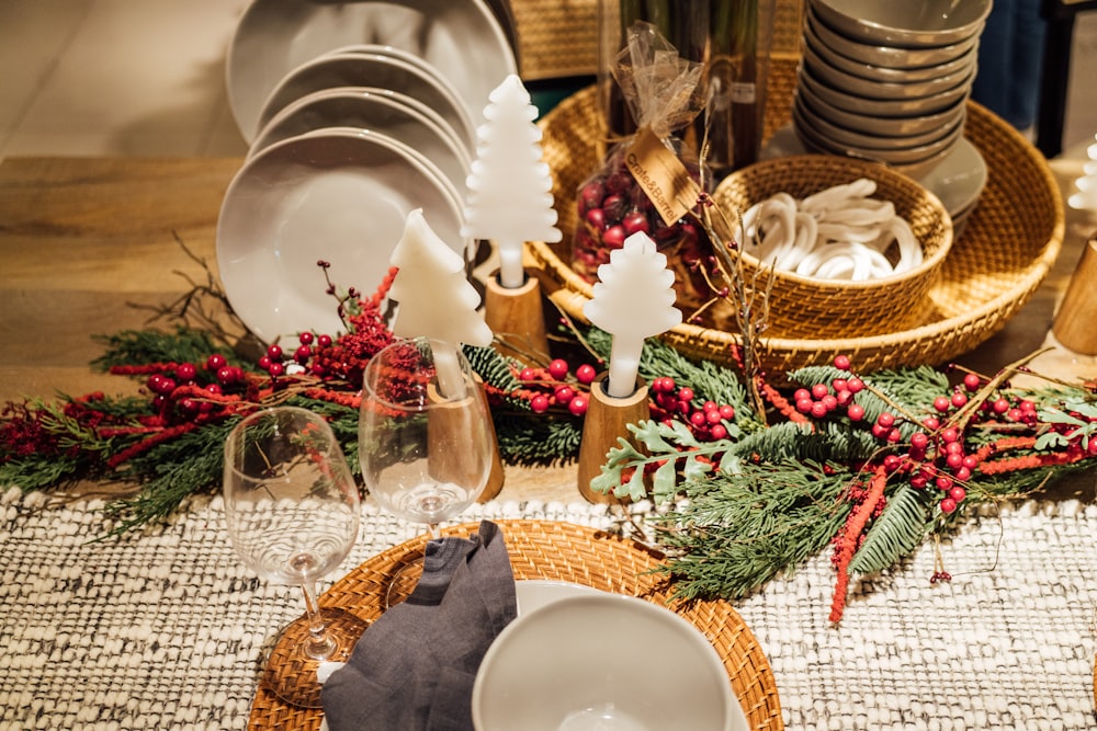 a table set for christmas with plates and wine glasses