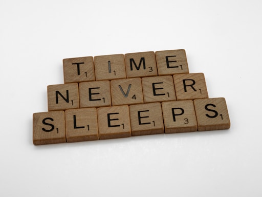 scrabble tiles spelling time never sleeps
