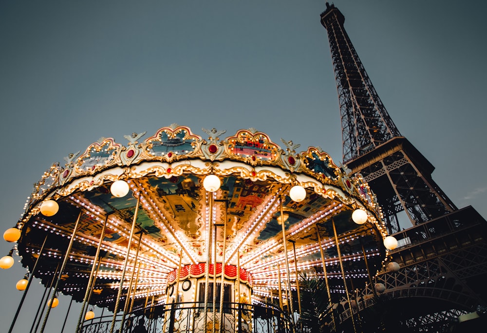 a carousel in front of the eiffel tower
