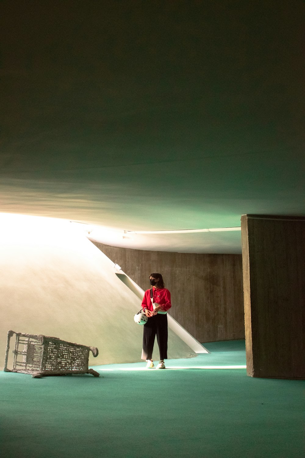 a man in a red shirt standing in a room