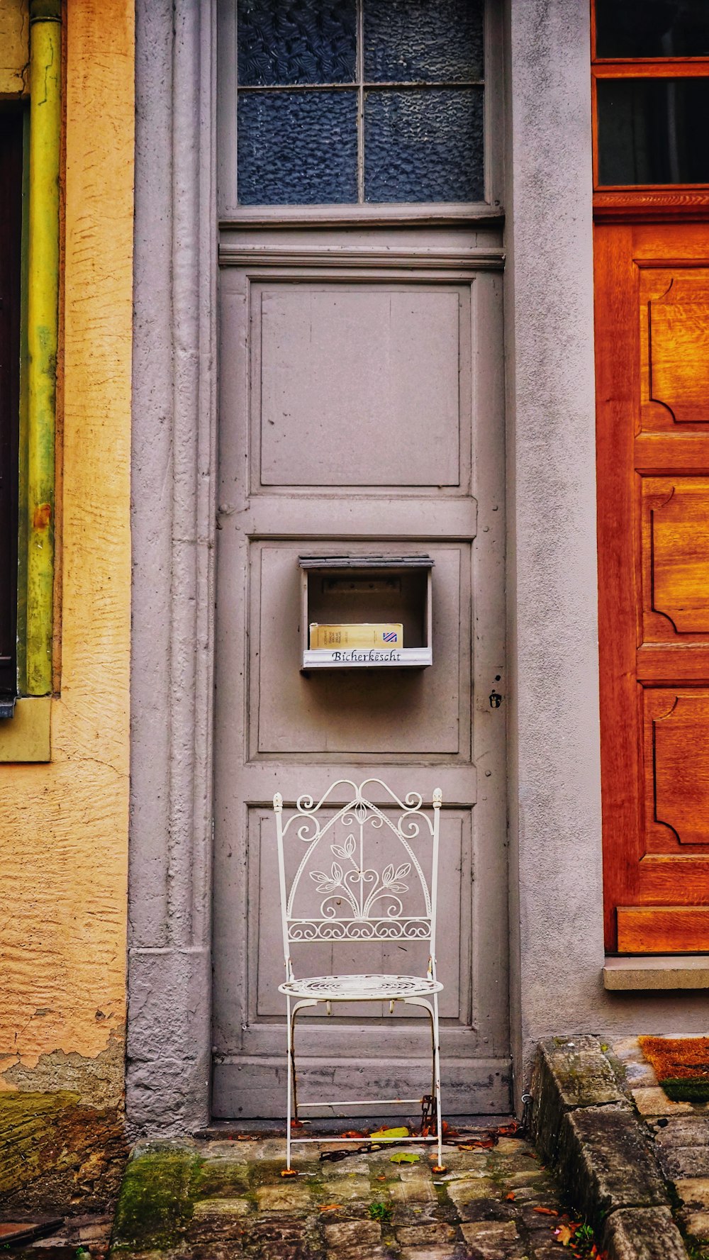 a white chair sitting in front of a door