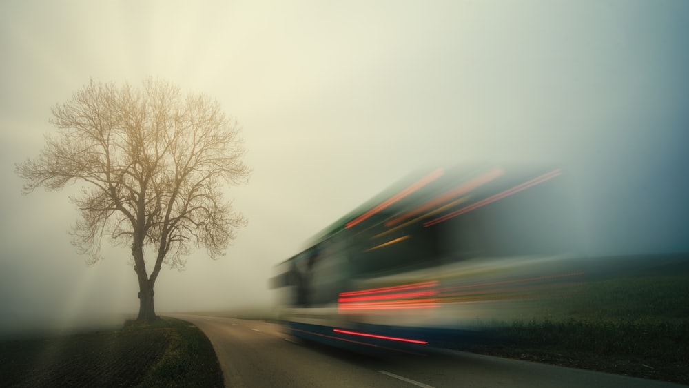 a blurry photo of a bus driving down a road