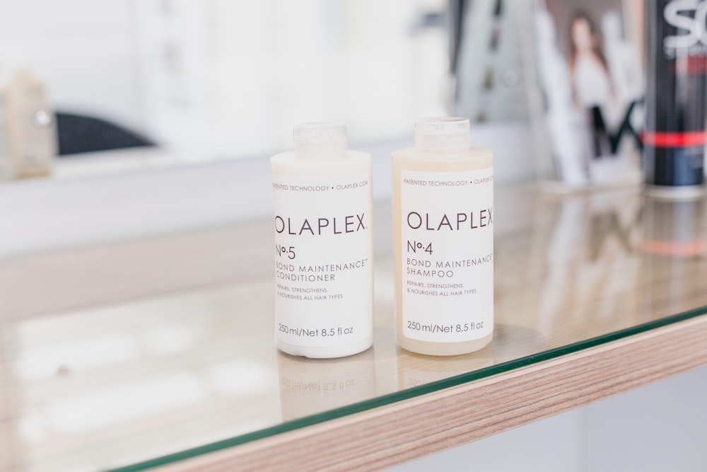 two bottles of olaplex are sitting on a counter