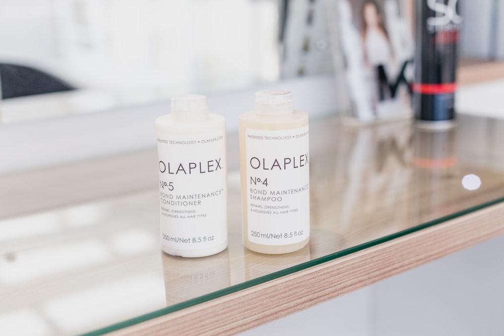 two bottles of olaplex on a table