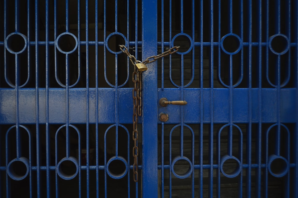 a close up of a blue metal door with a lock