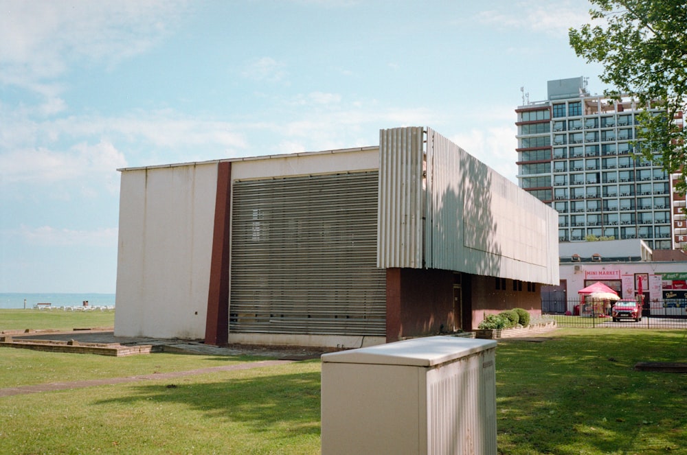 a large building sitting on top of a lush green field