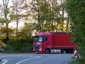 a red truck is parked on the side of the road