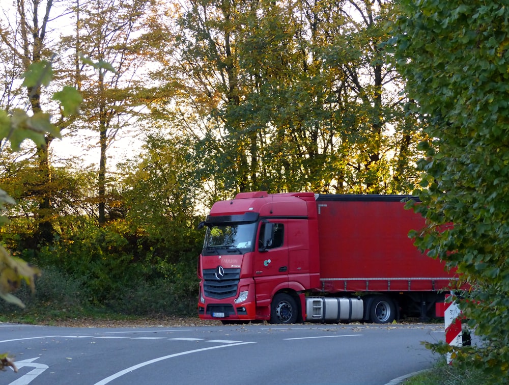 a red truck is parked on the side of the road