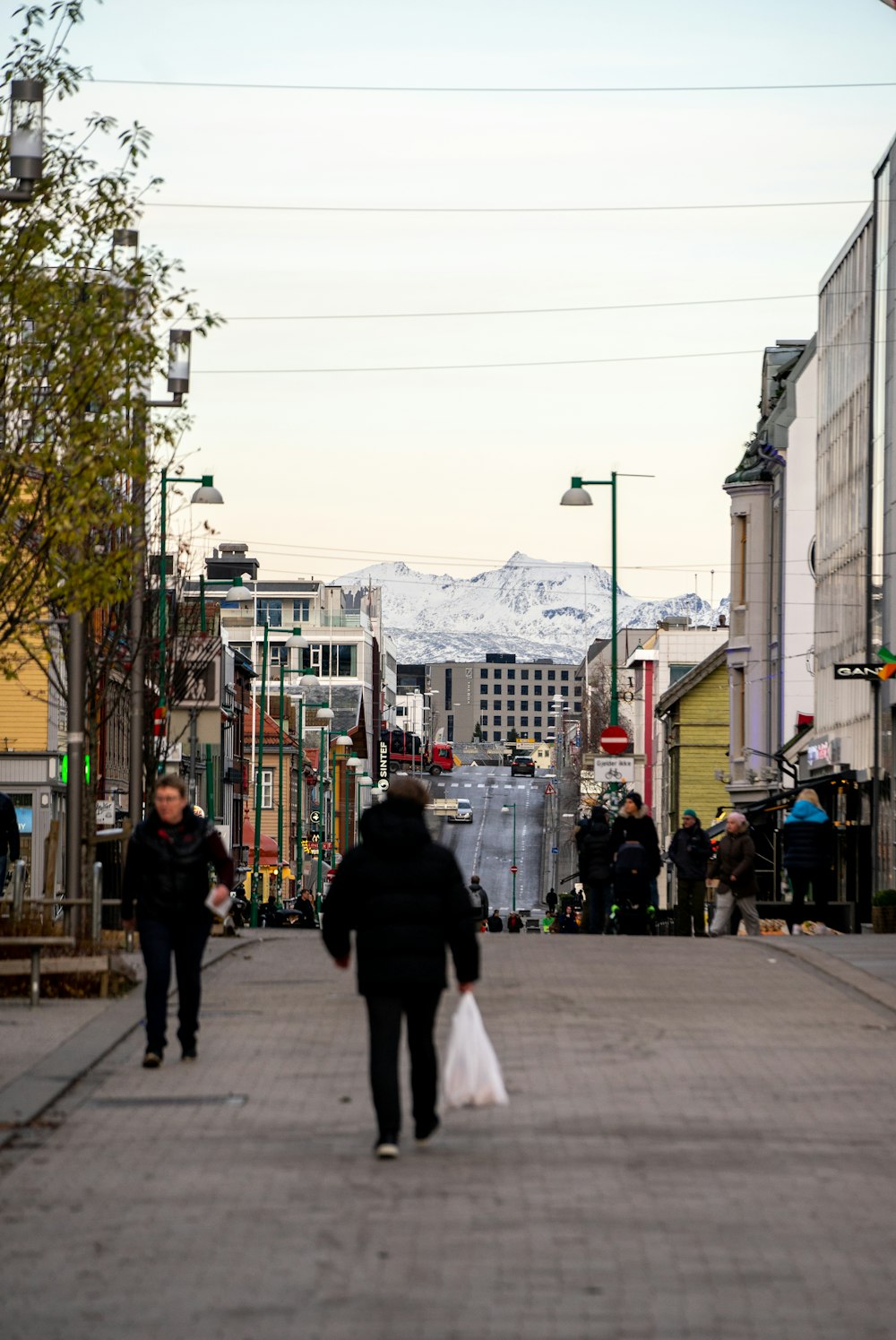 a couple of people that are walking down a street