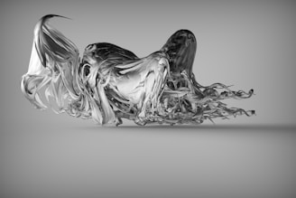 A complex abstract sculpture appears to be floating, featuring a fluid and dynamic form resembling twisted metal or liquid. The piece has flowing, wavy elements that create a sense of movement and fluidity.