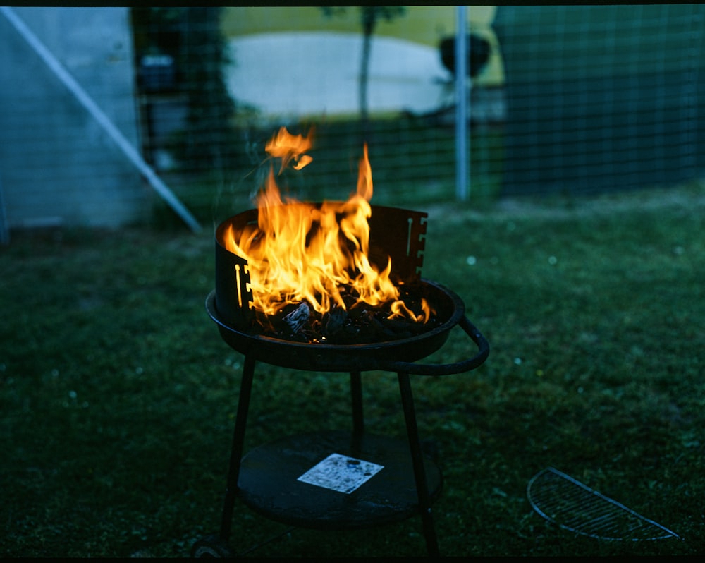 a bbq grill with a lot of flames on it