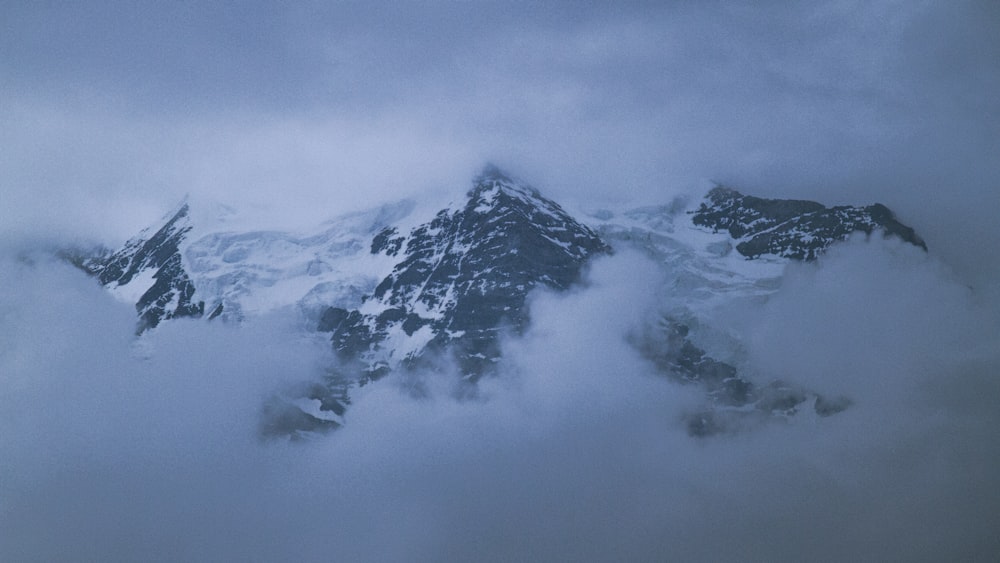 a view of a mountain covered in clouds