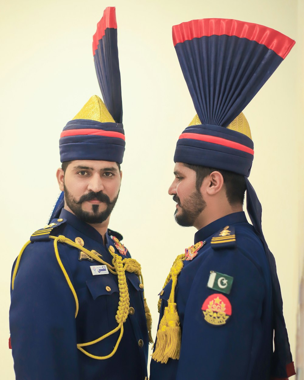 two men dressed in military uniforms standing next to each other