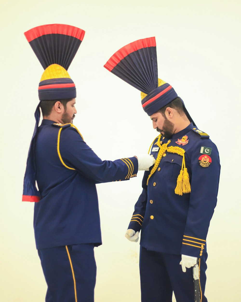 a couple of men in uniform standing next to each other