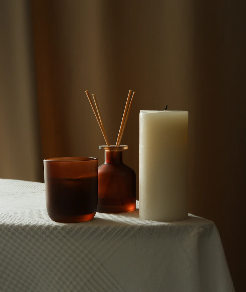 Luxurious home fragrance diffuser with warm amber tones in a cosy room