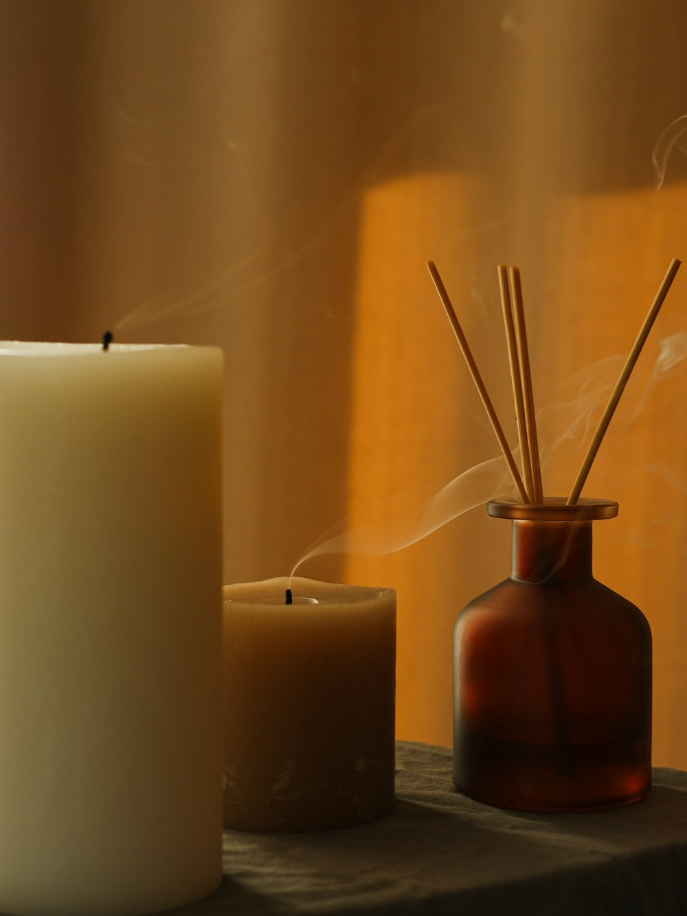 a couple of candles sitting on top of a table