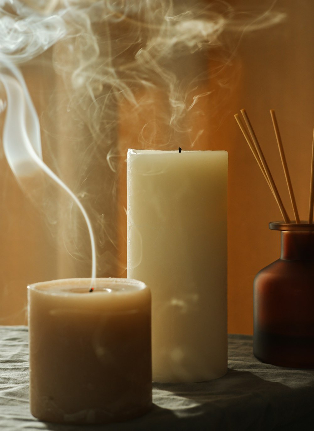 a couple of candles sitting on top of a table