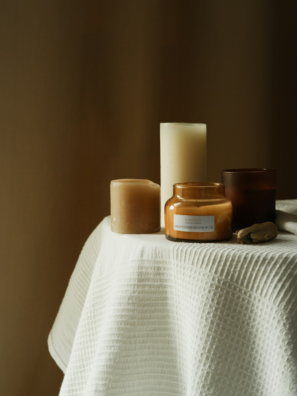 a table topped with candles and a white table cloth