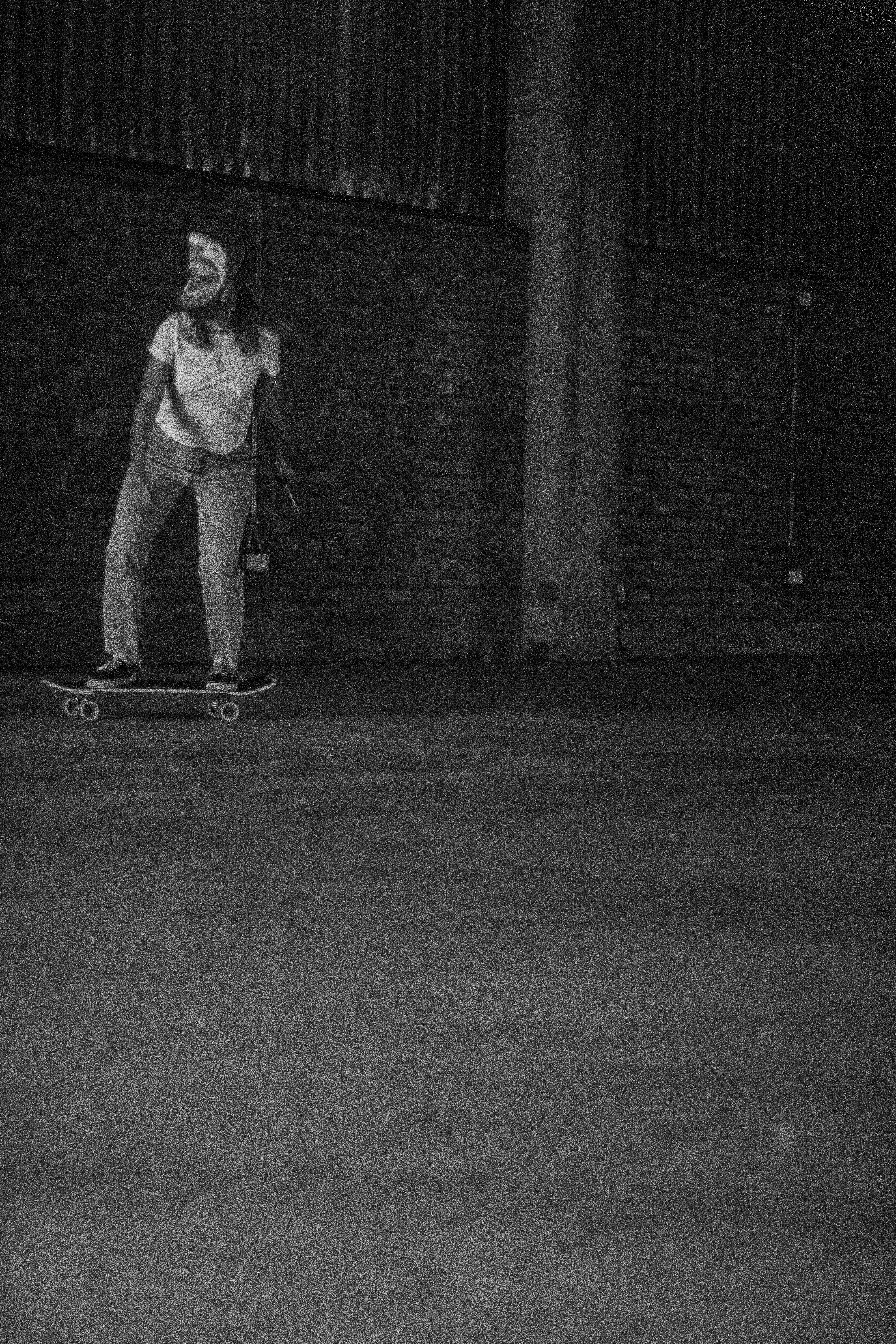 a man riding a skateboard down a street