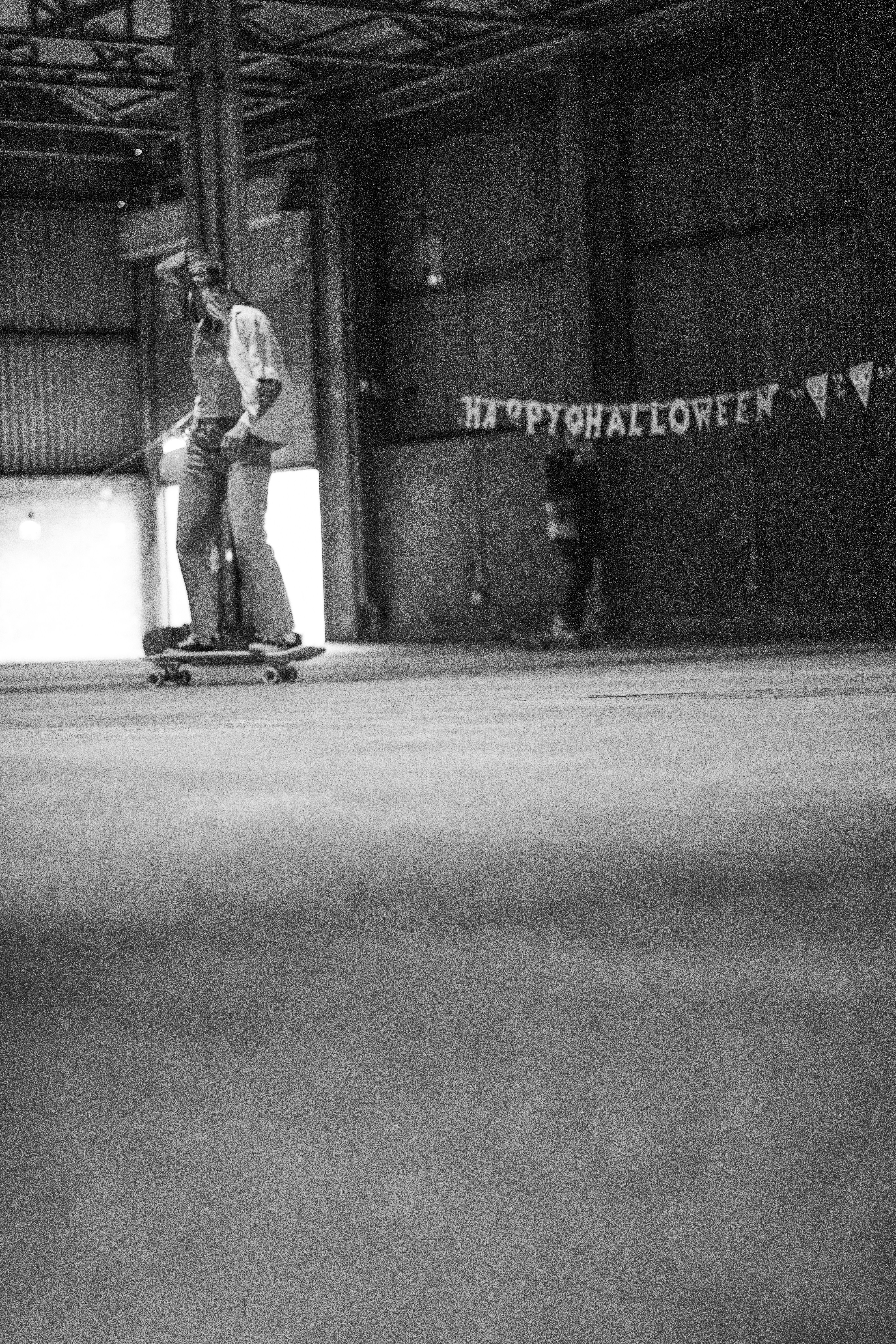 a man riding a skateboard inside of a warehouse