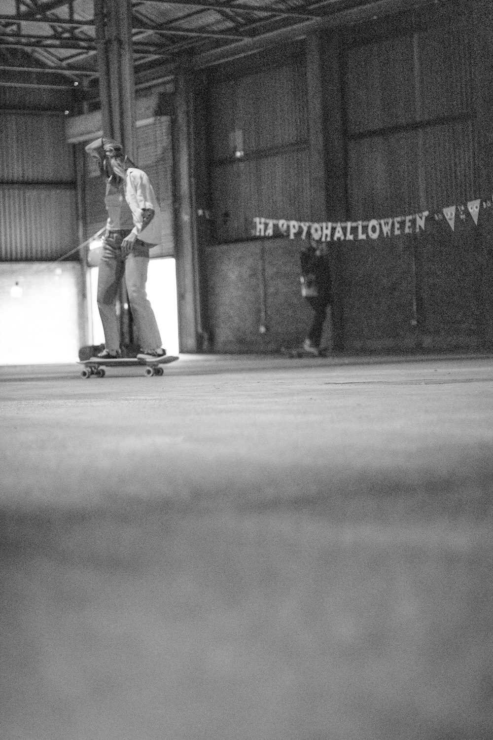 a man riding a skateboard inside of a warehouse