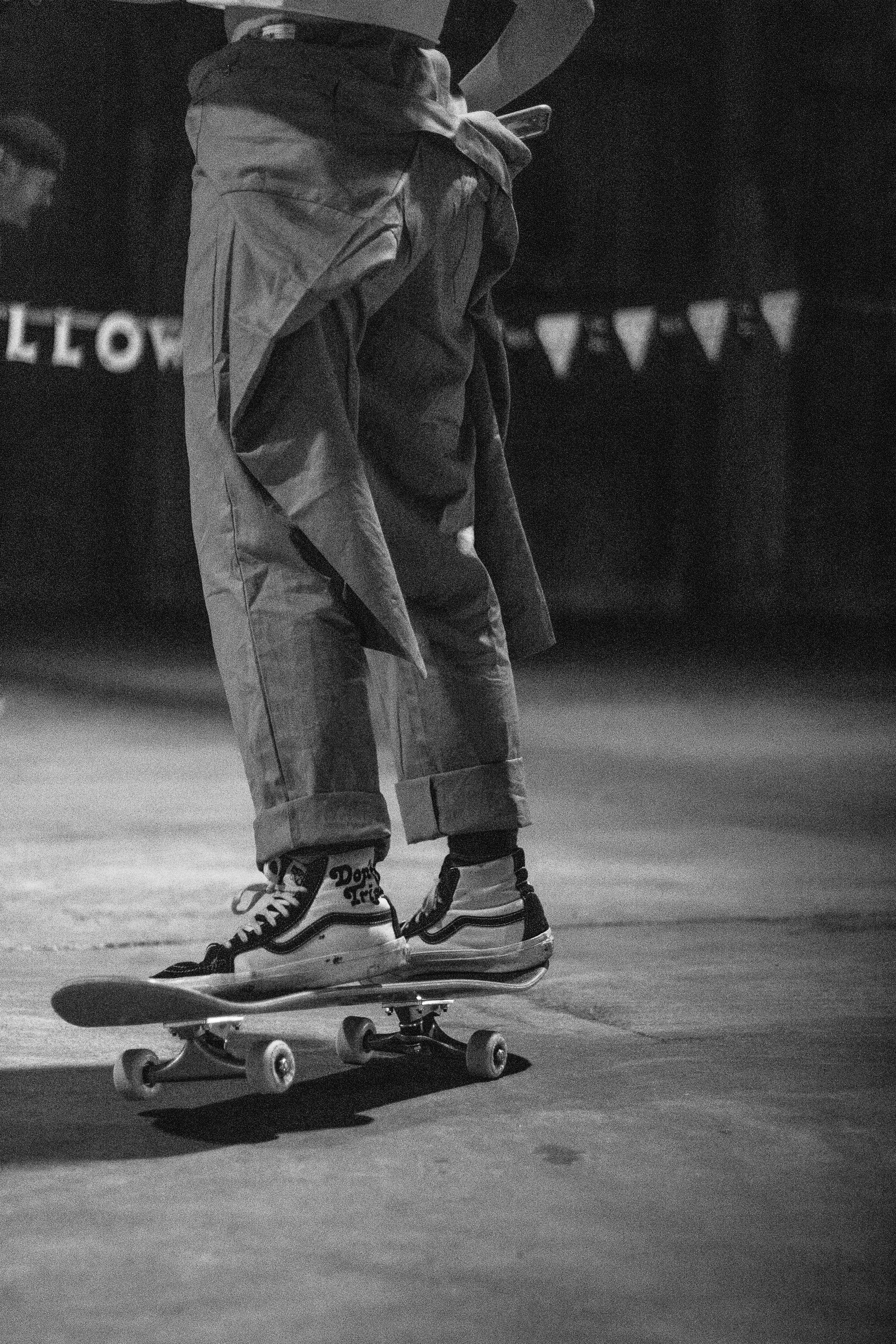 a black and white photo of a person on a skateboard