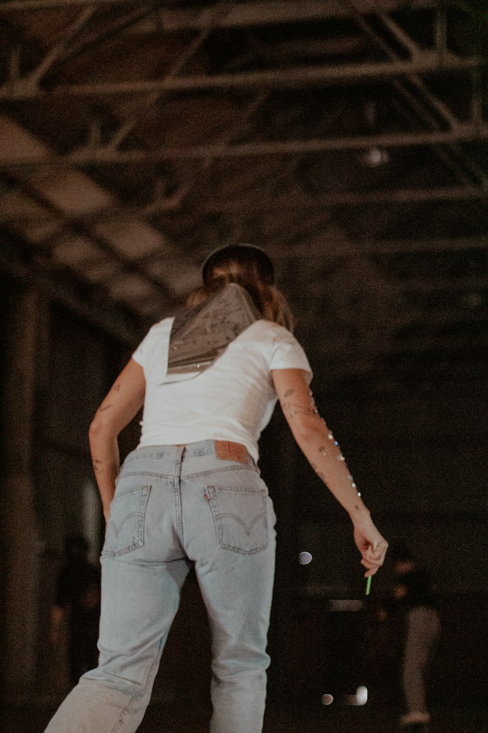 a person riding a skateboard in a warehouse