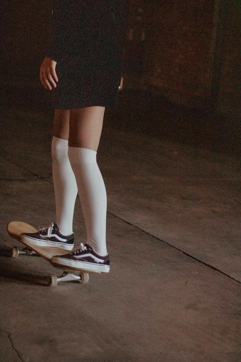a person riding a skateboard in a dark room