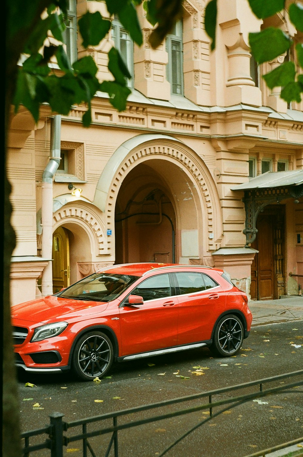 a red car parked in front of a building