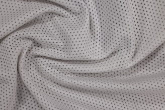 a close up view of a white polyester mesh fabric