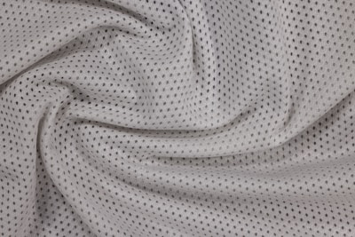 a close up view of a white polyester mesh fabric