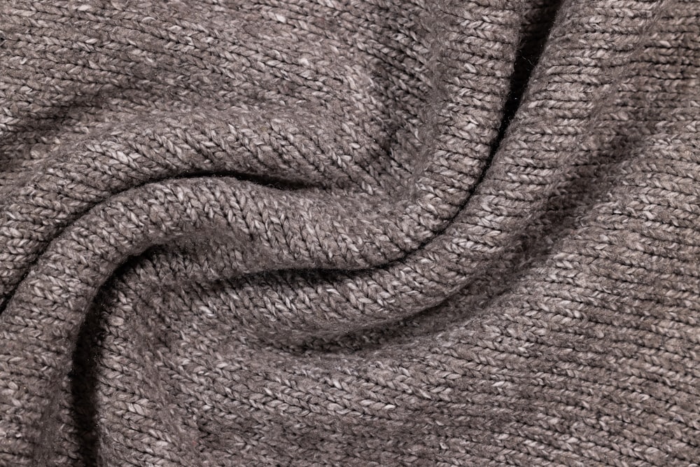 a close up view of a gray sweater