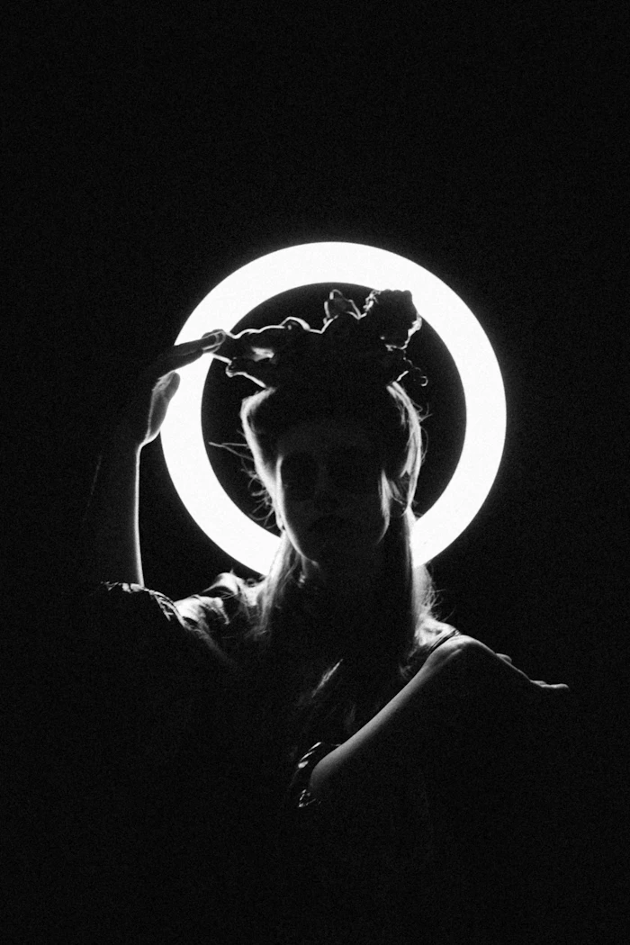 Creator in front of ring light