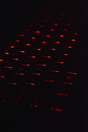 a close up of a computer keyboard in the dark