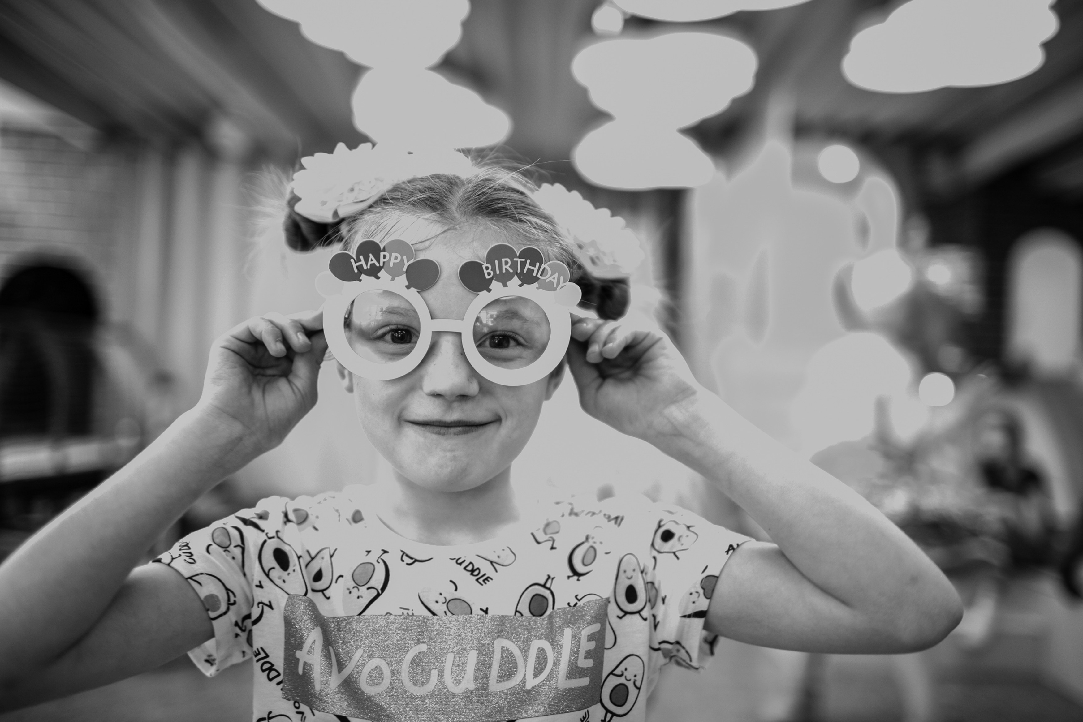 a little girl with some glasses on her face