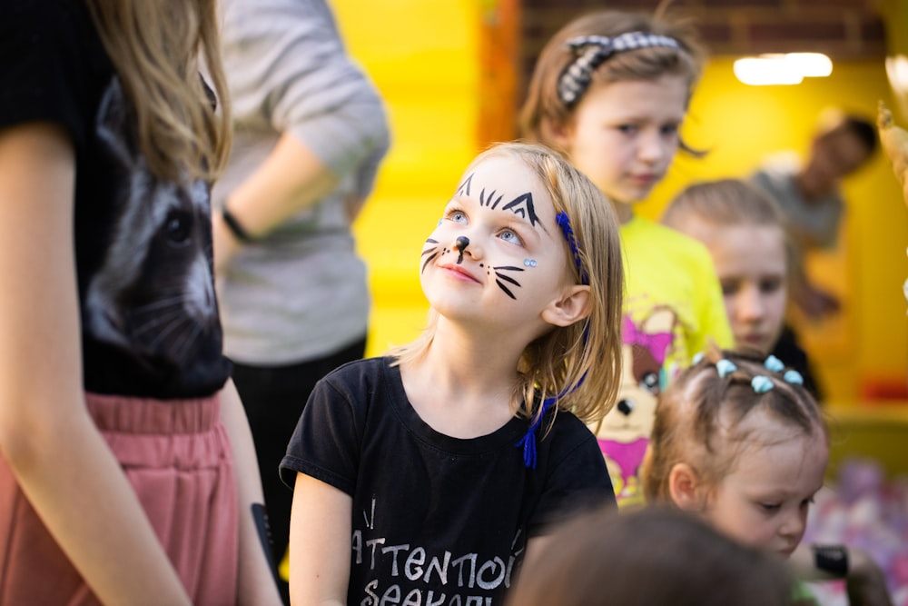 a group of children with face paint on