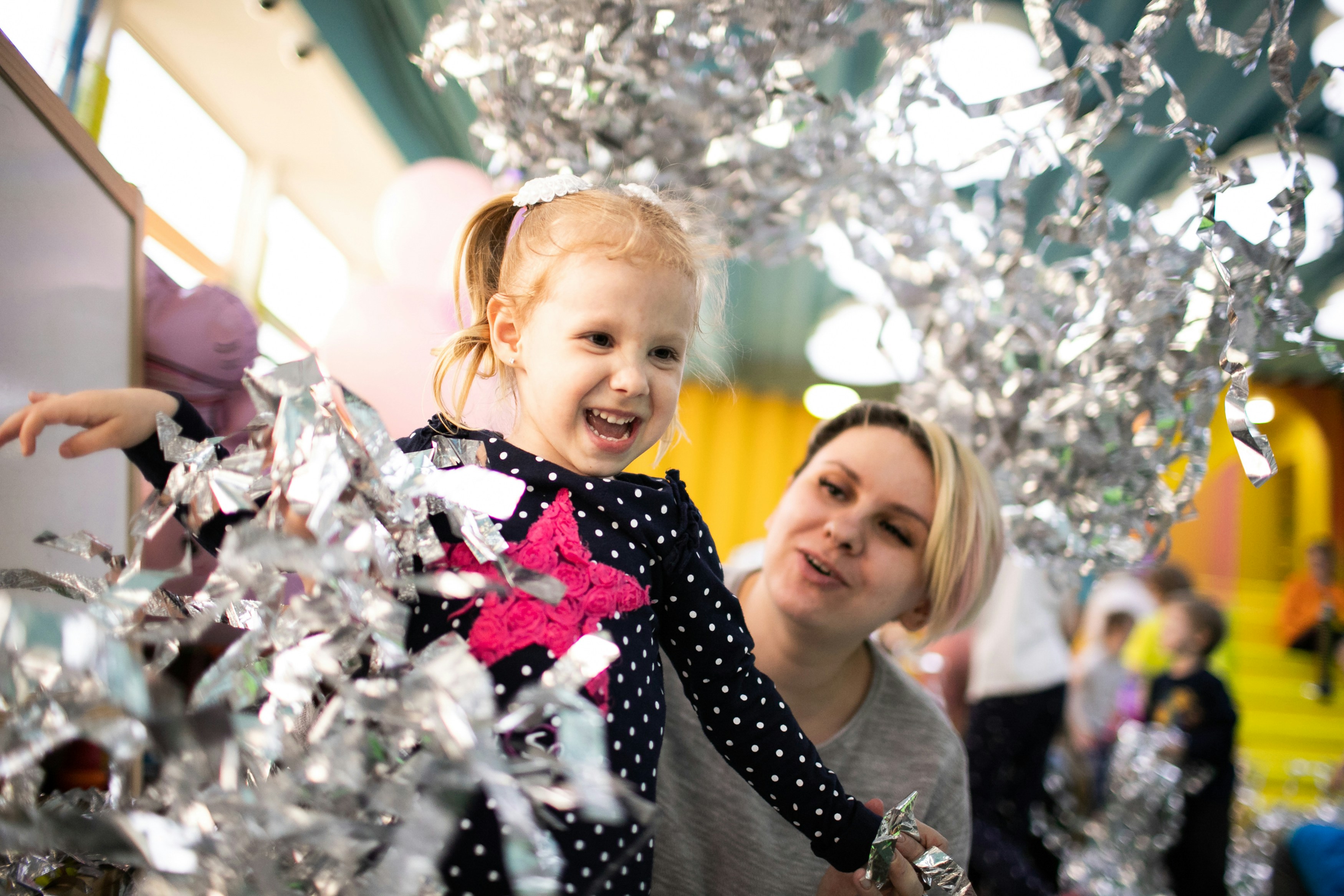 a woman and a little girl standing next to each other