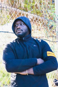 a man standing in front of a chain link fence agent de sécurité recrutement