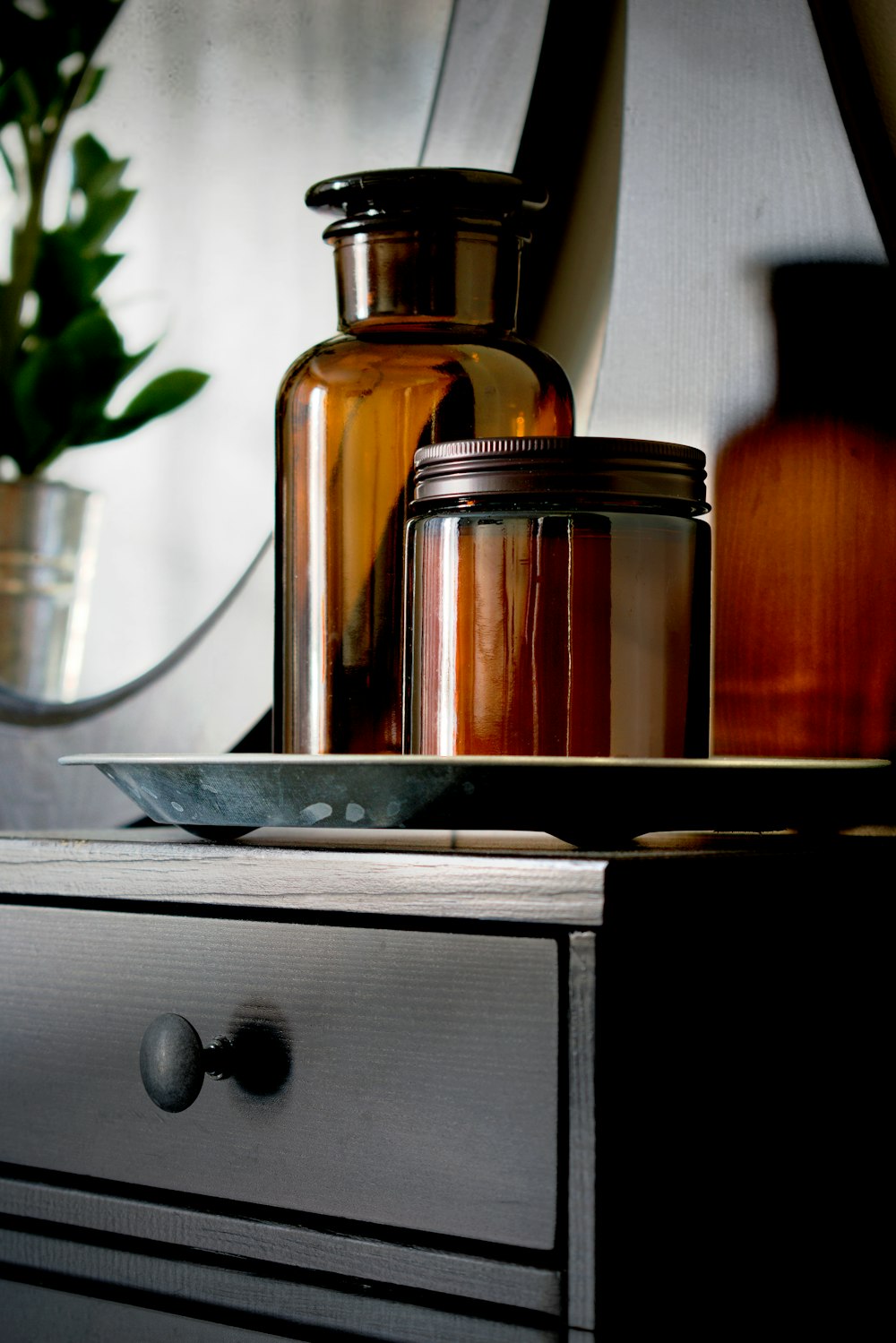 a table topped with jars and a vase filled with flowers