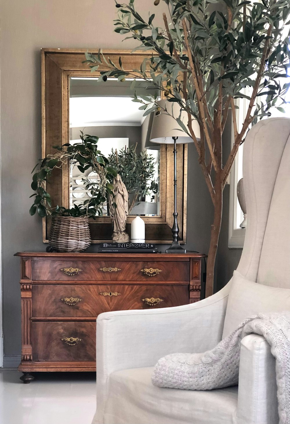 a room filled with furniture and vase of flowers