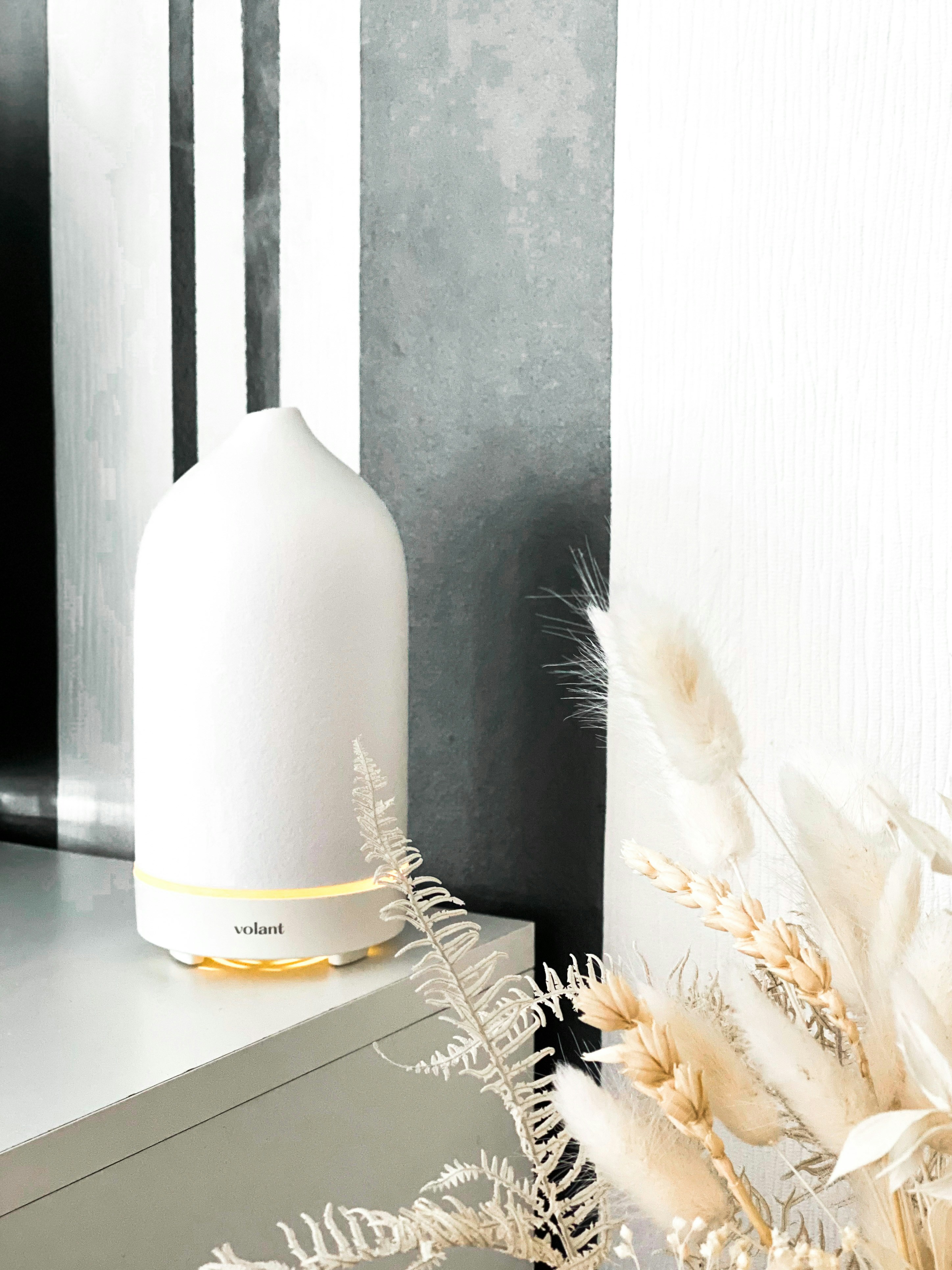 Service technician performing maintenance on fragrance diffuser system, professional service setting, warm ambient lighting