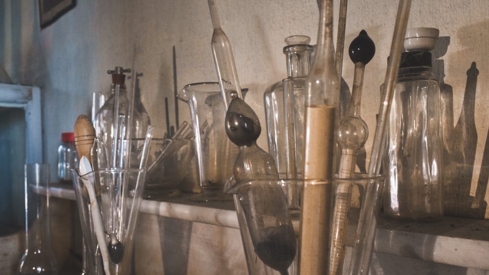 a shelf filled with lots of glass bottles and spoons