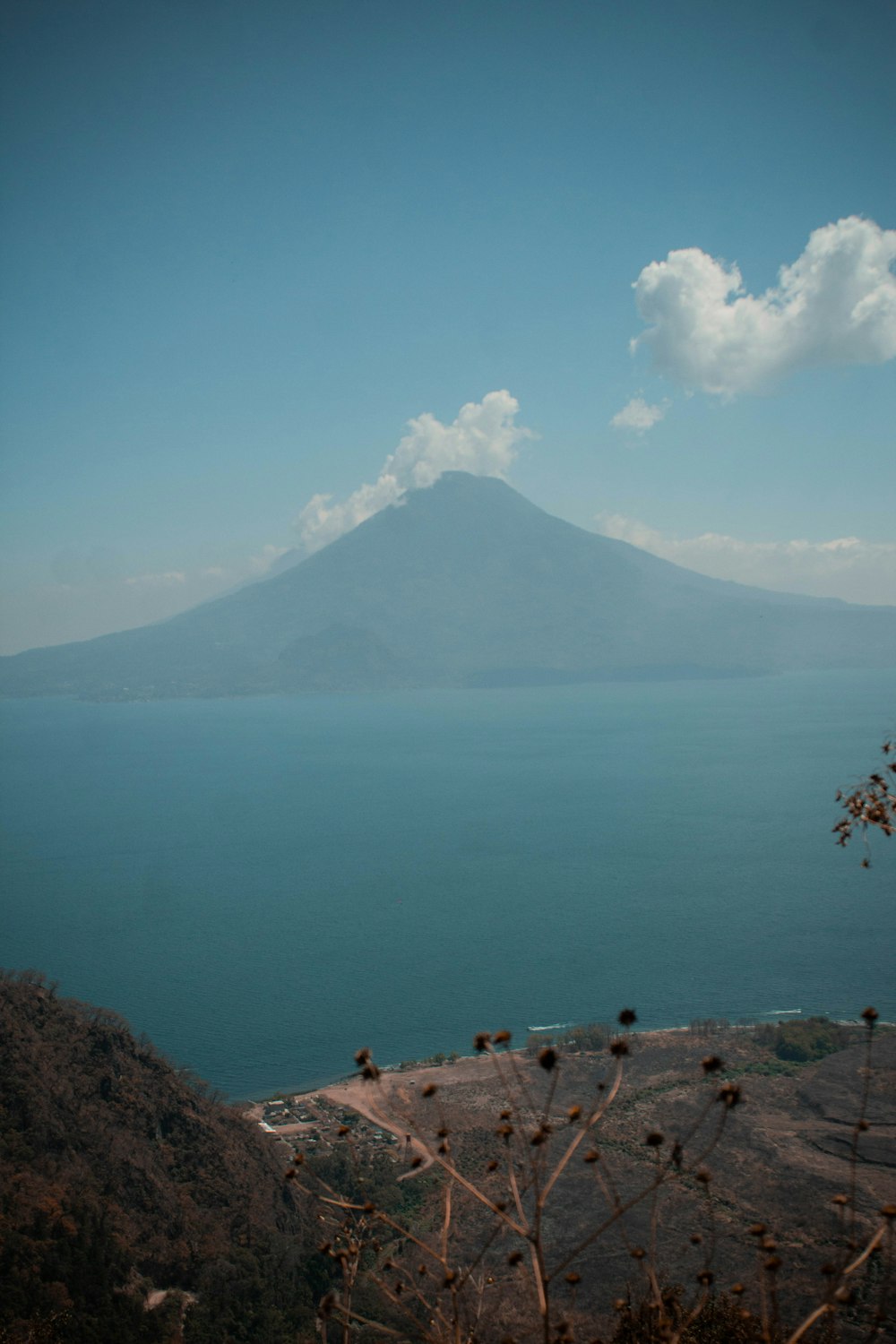 a large body of water with a mountain in the background