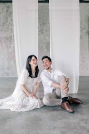 a man and a woman sitting on the ground