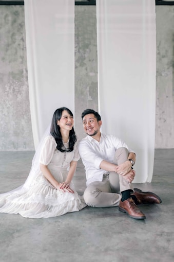 a man and a woman sitting on the ground