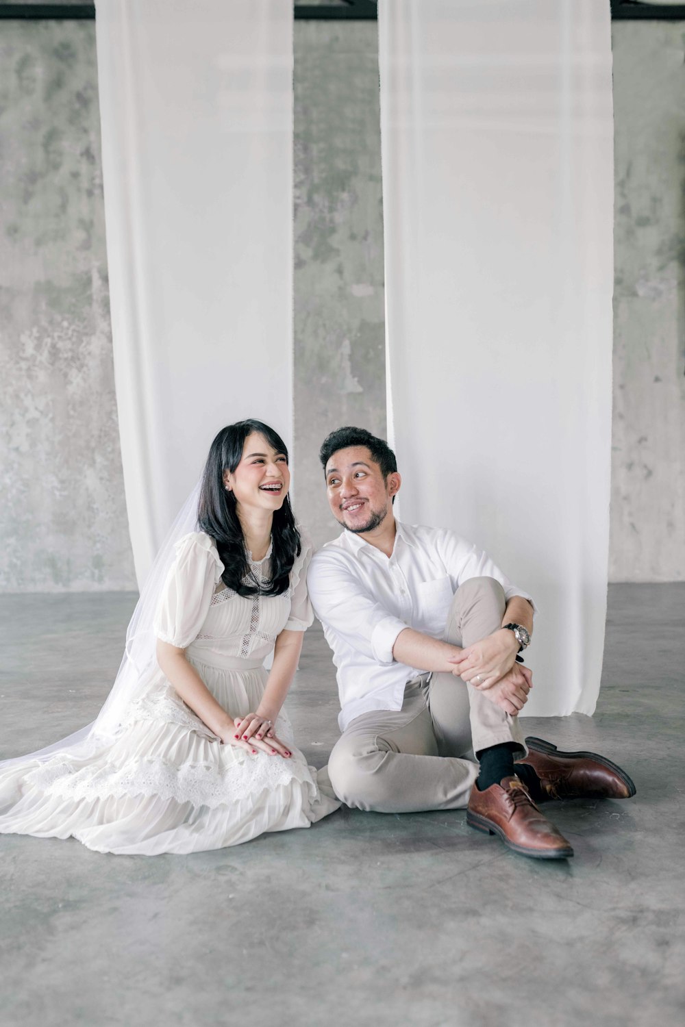 a man and a woman sitting on the ground