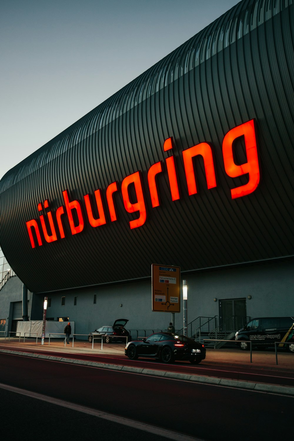 a large building with a neon sign on the side of it