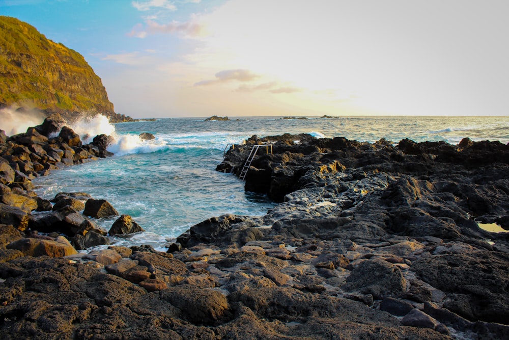 a rocky shore with waves crashing against the rocks